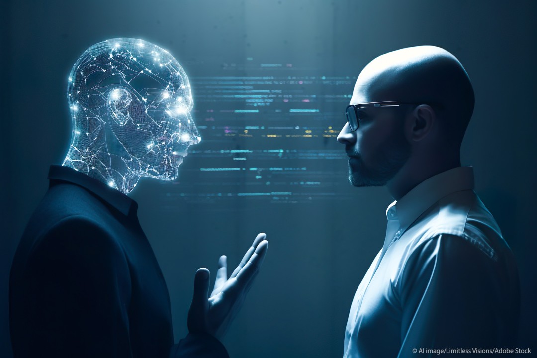 A man having a discussion with a digital, AI-generated human head.
