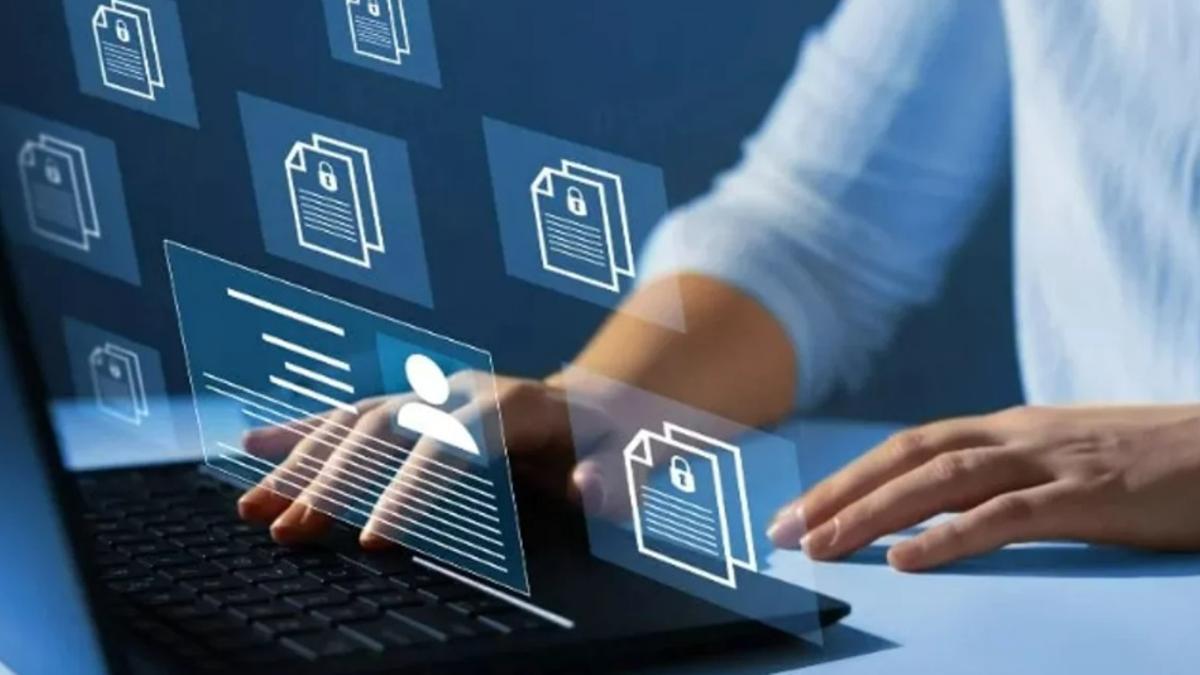 A person's hand on a laptop with a digital overlay showing secure document icons.