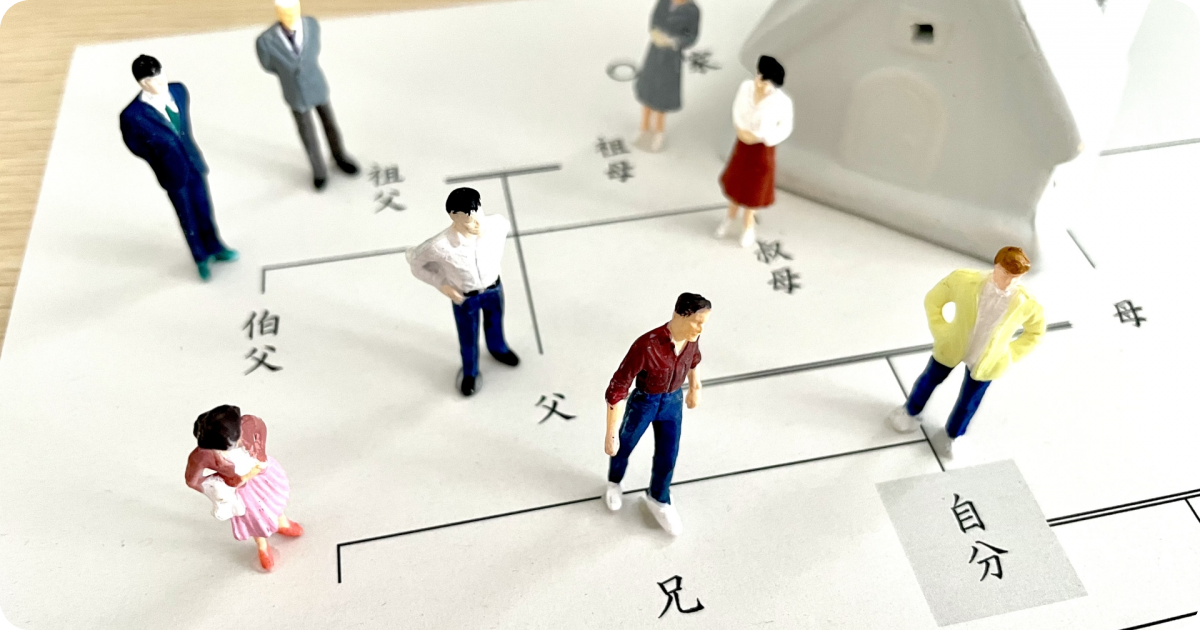 Miniature figurines placed on a Japanese family tree diagram (kakeizu).