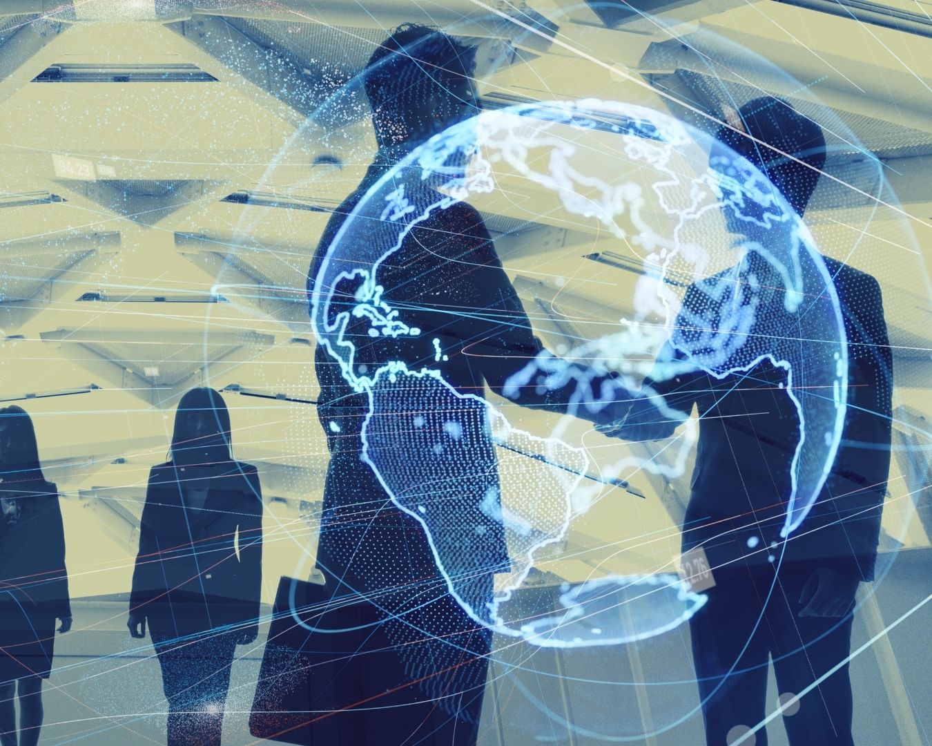 Silhouettes of business people shaking hands with a digital globe overlay.