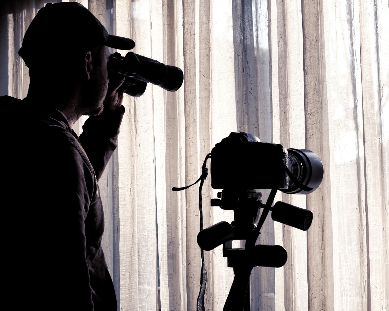 Silhouettes of business people shaking hands with a digital globe overlay.