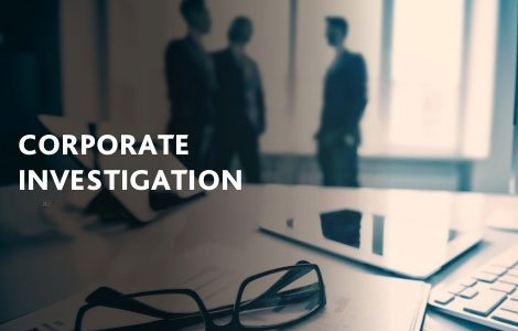 A desk with glasses and a laptop, with the words CORPORATE INVESTIGATION overlaid.