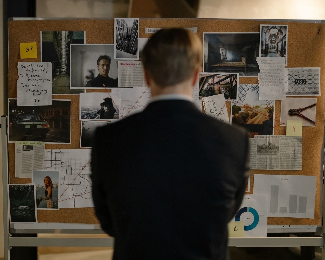 Magnifying glass over a twenty-dollar bill.