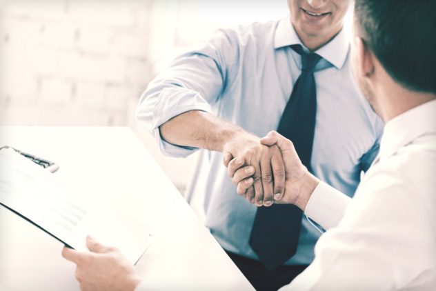 A close-up of a firm business handshake between two professionals.