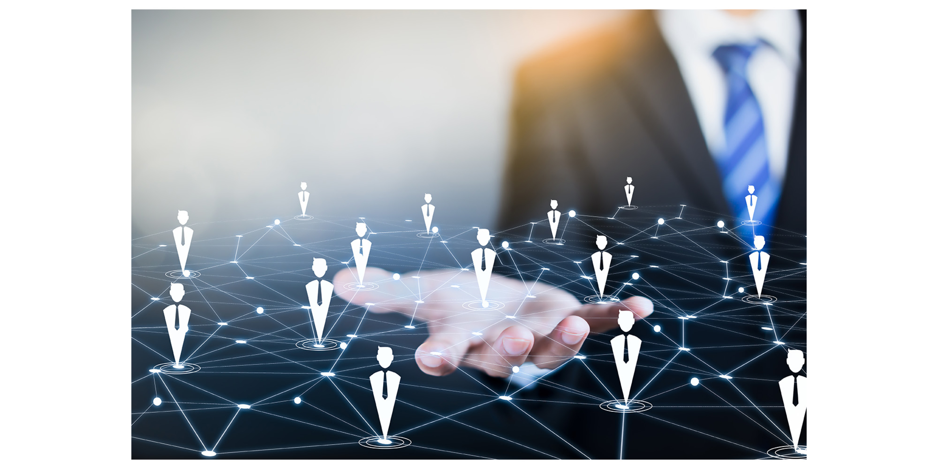 A hand holding a digital network of connected people icons.