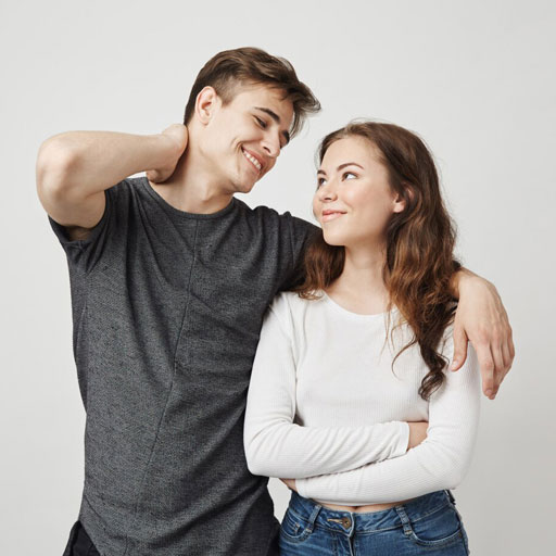 A happy young couple smiling at each other.